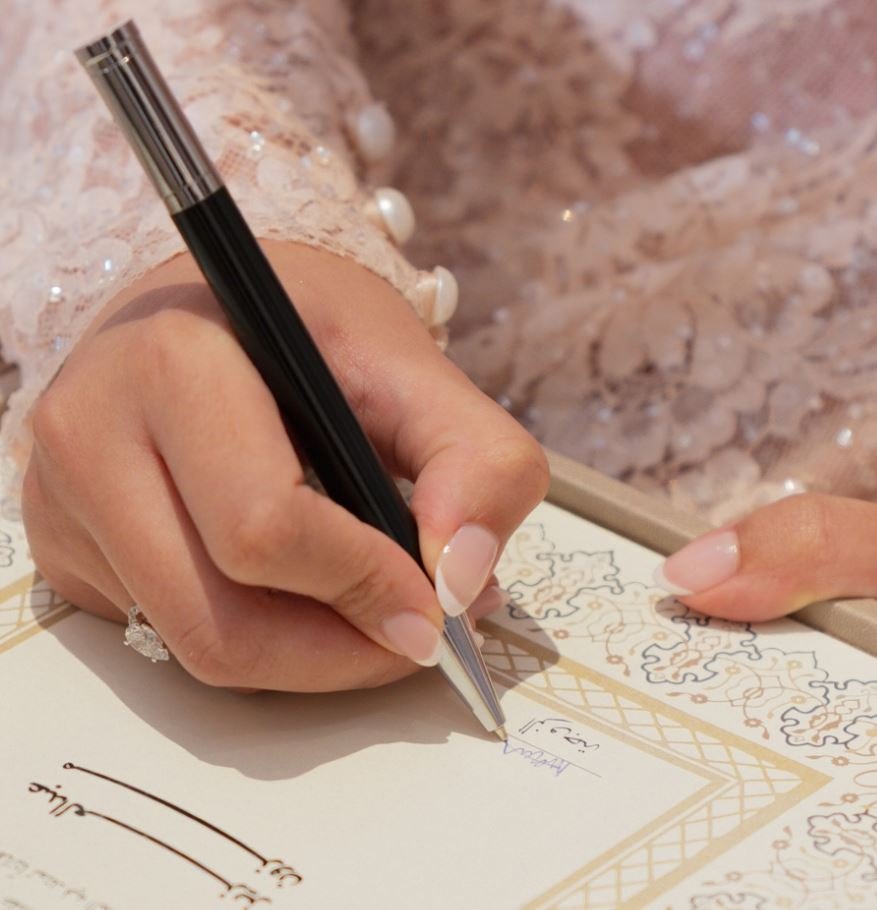 Bride signing the marriage contract